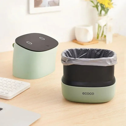 Sleek mini trash can with a soft-touch lid and built-in trash bag storage, perfect for home or office use.

