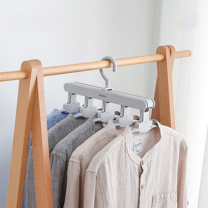 Foldable and adjustable Ecoco clothes hanger designed to hold multiple garments, maximizing wardrobe and drying space efficiently.