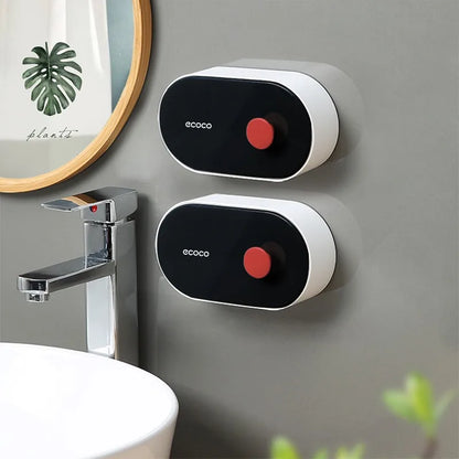 Stylish gray Ecoco soap organizer with a blue button, wall-mounted for space-saving and mess-free bathroom storage.