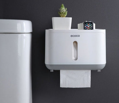 Modern Ecoco toilet paper dispenser with a flat storage surface for small decor or personal items.

