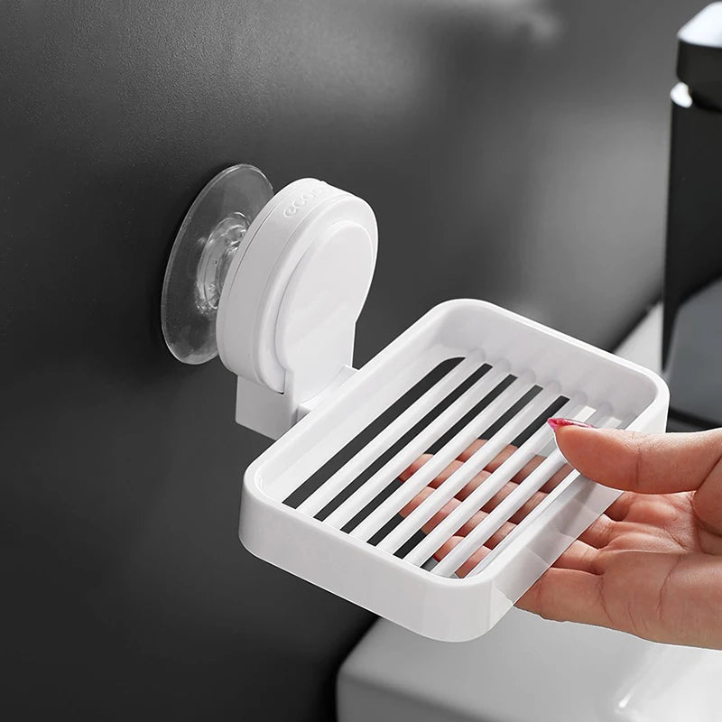 White Ecoco soap dish with a drainage design and suction mount for easy and secure installation on bathroom walls.

