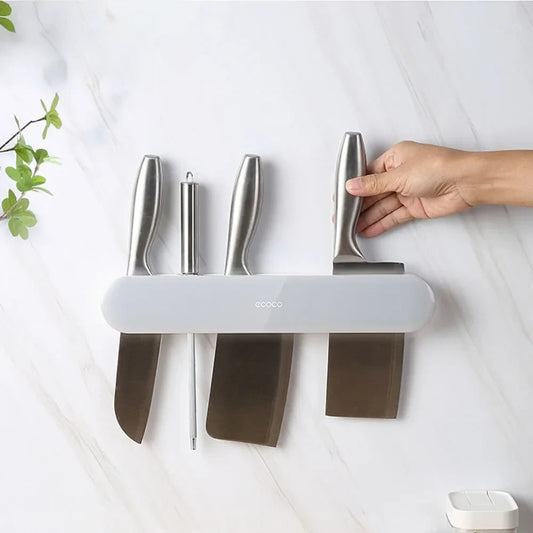 Modern Ecoco knife holder with a sleek magnetic strip and hooks for organizing knives and kitchen tools.

