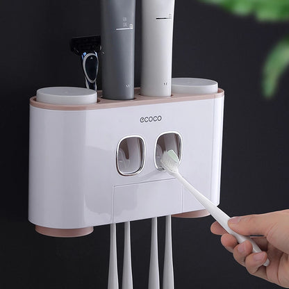 Minimalist Ecoco wall-mounted toothpaste dispenser with storage cups, toothbrush slots, and a sleek design for organized bathrooms.

