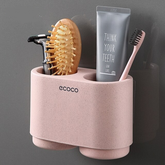 Modern pink wall-mounted caddy with versatile slots for holding brushes, razors, and toothpaste, ideal for tidy bathroom storage.


