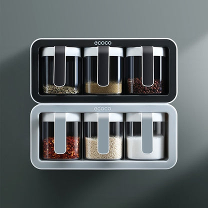 Close-up view of the Ecoco spice storage box featuring a transparent container and ergonomic scoop for easy access.

