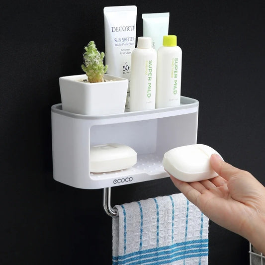 Compact white Ecoco bathroom shelf with towel hook, perfect for organizing soap, toiletries, and towels in a modern bathroom.

