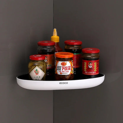 A compact corner wall-mounted shelf for the kitchen, suitable for storing condiments, jars, and sauces. The black and white design blends seamlessly with modern kitchens.