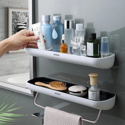 Compact and durable wall-mounted rack for storing personal care items, featuring a convenient towel holder.

