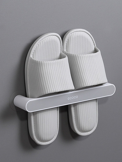 Minimalist gray Ecoco wall-mounted slipper holder, designed to keep slippers dry and neatly stored in bathrooms or entryways.