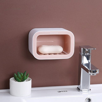 Functional wall-mounted holder with dual compartments and a flat top, perfect for soaps, sponges, and small items like watches or phones.

