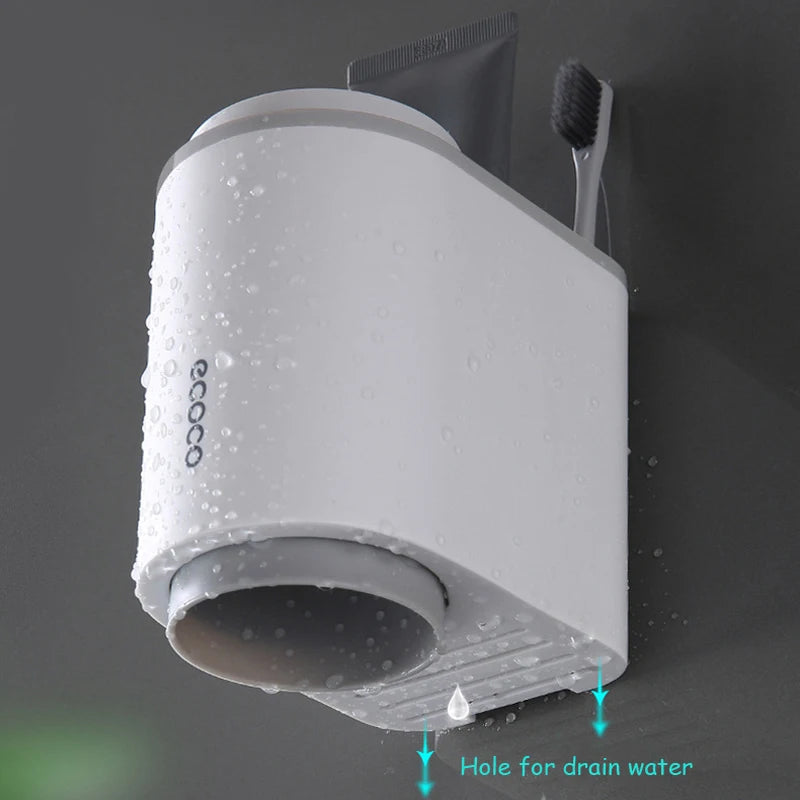 Wall-mounted Ecoco toothpaste dispenser with toothbrush slots for a space-saving, hygienic bathroom organization.

