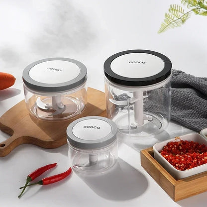 Compact manual food chopper with a pull-string mechanism, perfect for mincing garlic, chili, and vegetables.

