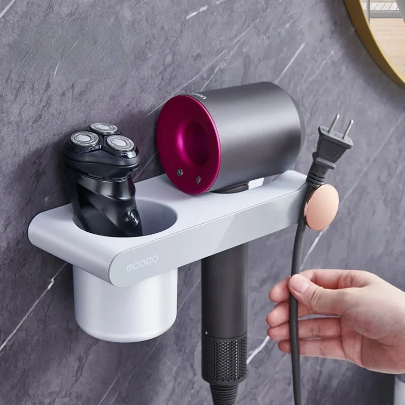 Space-saving wall-mounted hair dryer holder with a secure magnetic grip, perfect for keeping the bathroom neat and organized.