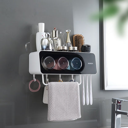 ecoco Wall-mounted multi-functional kitchen storage rack with four integrated cups, a top shelf for toiletries or kitchen essentials, hanging hooks for towels and accessories, and a sleek modern design.