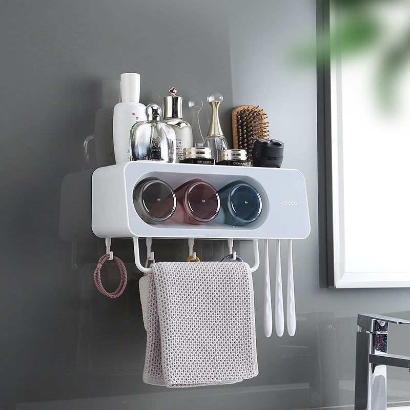 ecoco Wall-mounted multi-functional kitchen storage rack with four integrated cups, a top shelf for toiletries or kitchen essentials, hanging hooks for towels and accessories, and a sleek modern design.