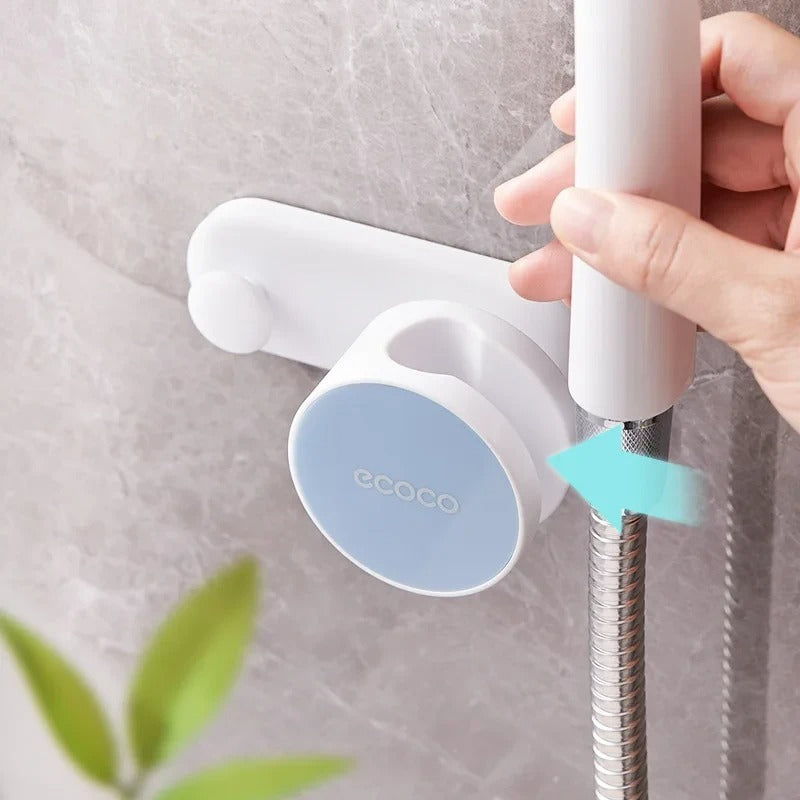 Wall-mounted shower head holder in blue and white with ergonomic design for adjustable spray angles.