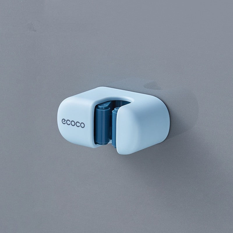 Minimalist baby blue Ecoco holder mounted on a wall, securely holding a mop handle for easy access and organization.